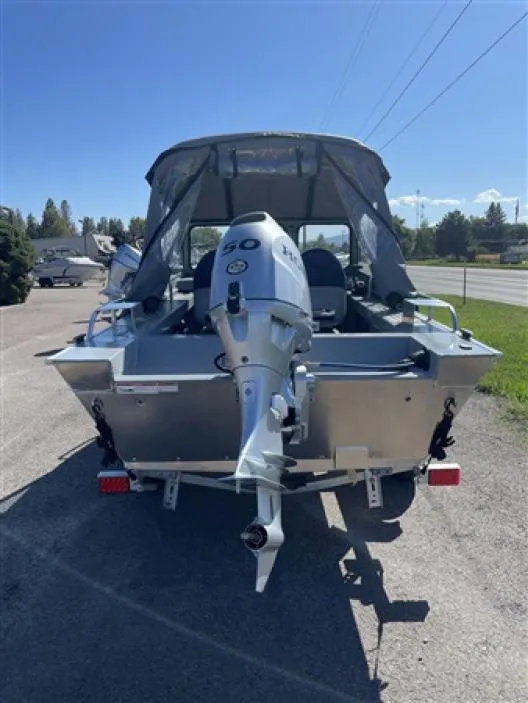 Slide: The Image of 2023 Klamath 16 Explorer Windshield boat with outboard motor, rear view. - 2