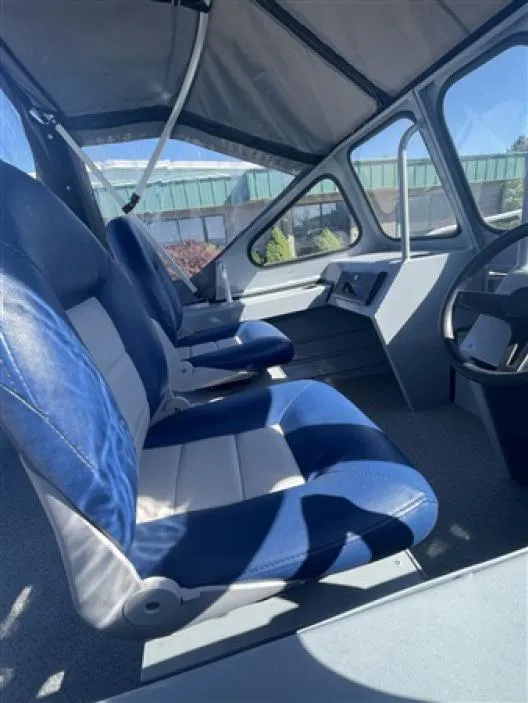 Slide: The Image of Interior of 2023 Klamath 16 Explorer Windshield boat with blue and white seats. - 4
