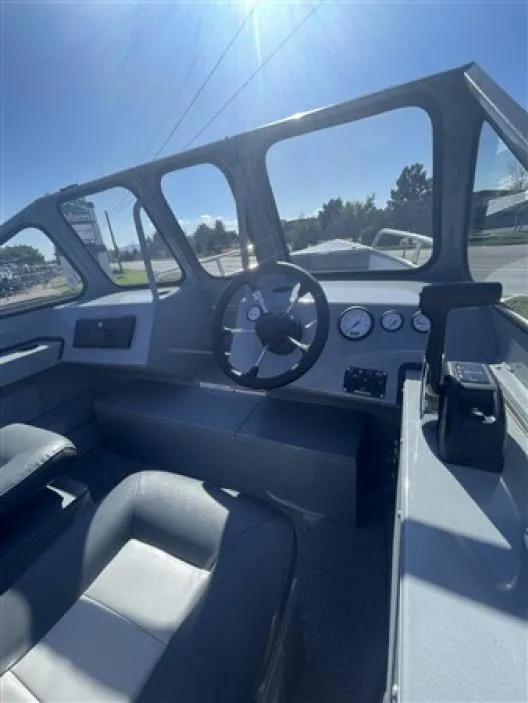 Slide: The Image of 2023 Klamath 18 Open Windshield boat interior with steering wheel and dashboard. - 5