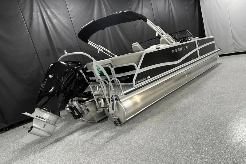 Slide: The Image of 2024 Premier 250 Solaris Sport pontoon boat with Mercury outboard engine in showroom. - 1