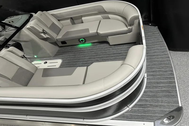 Slide: The Image of 2024 Premier 250 Solaris Sport boat interior with gray seating and green LED lighting. - 13