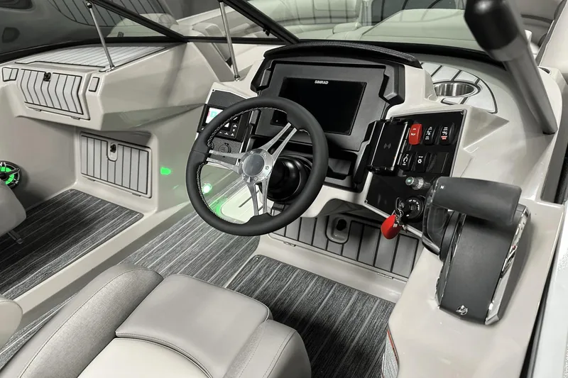 Slide: The Image of 2024 Premier 250 Solaris Sport boat dashboard with modern controls and steering wheel. - 18