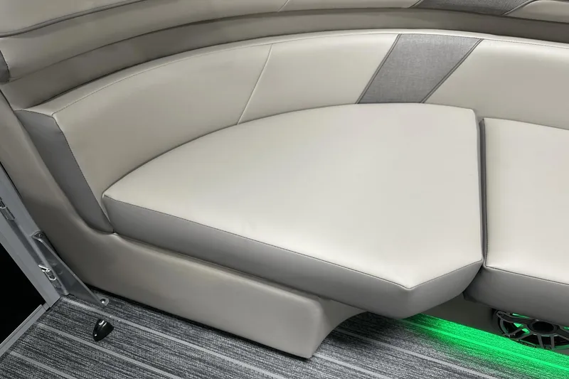 Slide: The Image of 2024 Premier 250 Solaris Sport boat interior with gray cushioned seating and green LED lighting. - 46