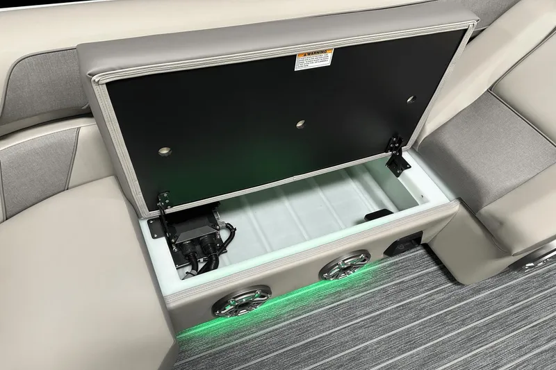 Slide: The Image of 2024 Premier 250 Solaris Sport boat storage compartment with LED lighting and speaker system. - 49