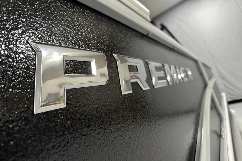Slide: The Image of Close-up of 2024 Premier 250 Solaris Sport boat logo on textured black surface. - 8