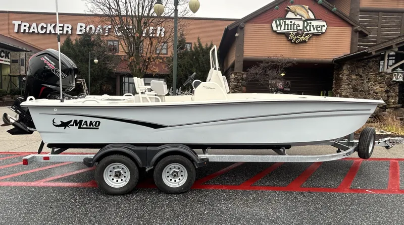Slide: The Image of 2024 Mako Pro Skiff 19 CC boat on trailer outside White River Outpost. - 0