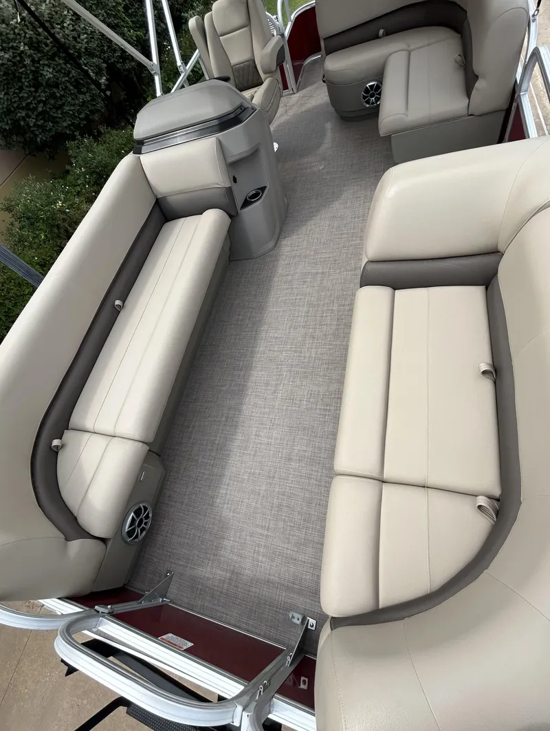 Slide: The Image of 2024 Sun Tracker Party Barge 18 DLX interior with beige seating and spacious layout. - 3