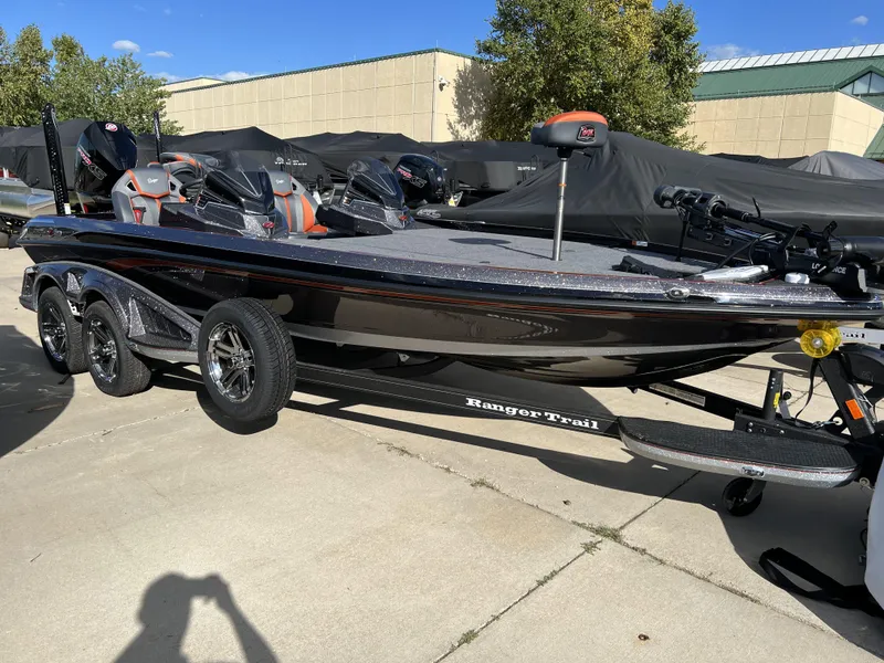 Slide: The Image of 2024 Ranger Z521R Ranger Cup Equipped boat on a trailer in a parking lot. - 2
