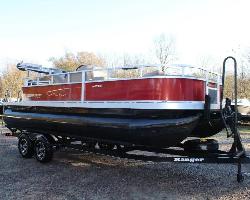 Slide: The Image of 2024 Ranger Reata 200F pontoon boat on a trailer. - 1