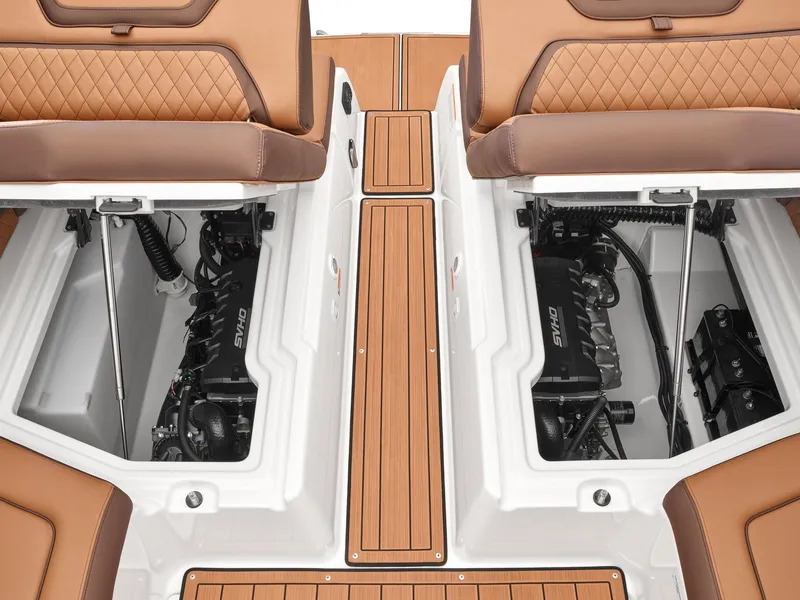 Slide: The Image of 2024 Yamaha Boats 275SE engine compartments with teak flooring and brown leather seats. - 3