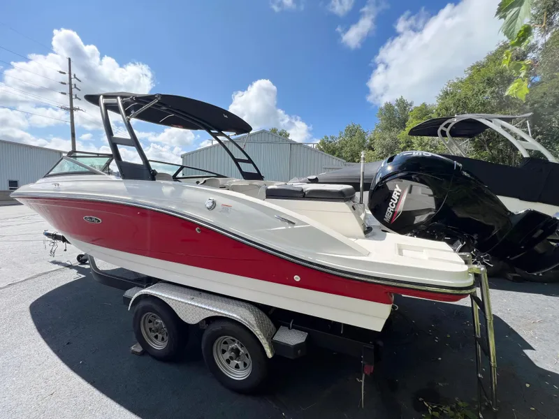 Slide: The Image of 2021 Sea Ray SPO 210 boat with red and white exterior on a trailer. - 0