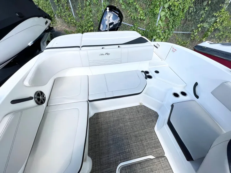 Slide: The Image of 2021 Sea Ray SPO 210 boat interior with white seating and cup holders. - 10