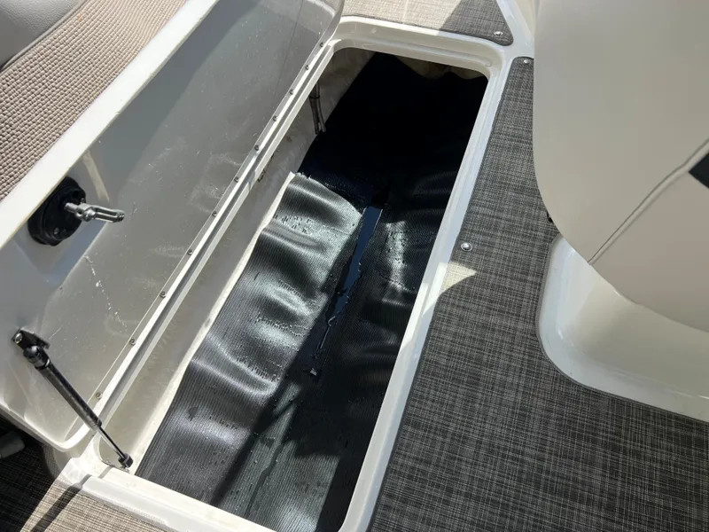 Slide: The Image of Open storage compartment in 2021 Sea Ray SPO 210 boat interior. - 11