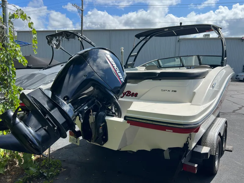 Slide: The Image of 2021 Sea Ray SPO 210 boat with Mercury outboard motor in a parking lot. - 12