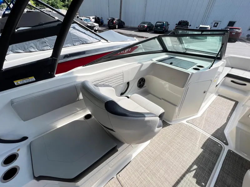 Slide: The Image of 2021 Sea Ray SPO 210 boat interior with seating and dashboard. - 4