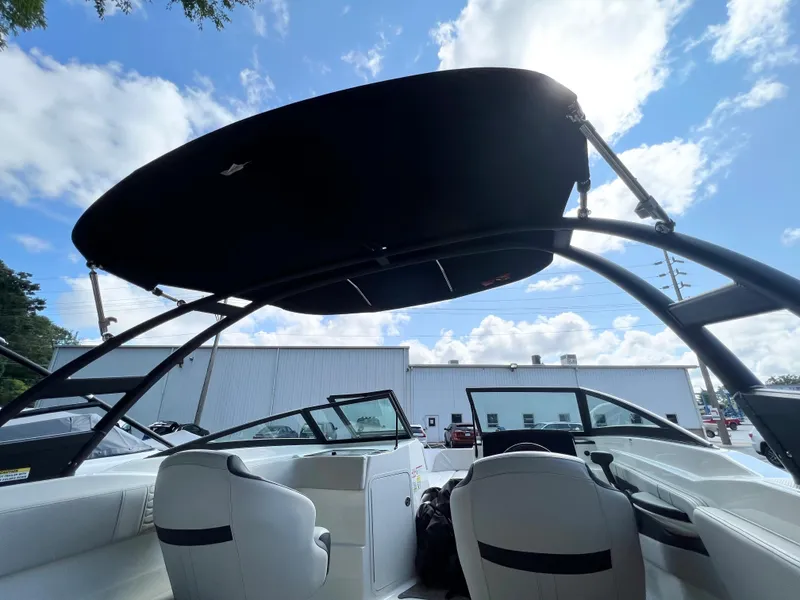 Slide: The Image of 2021 Sea Ray SPO 210 boat interior with canopy under blue sky. - 5