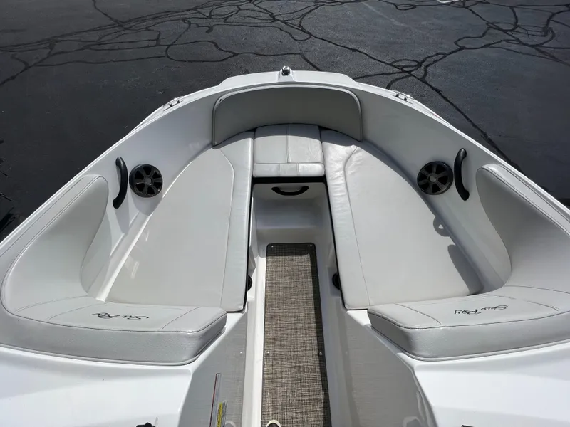 Slide: The Image of 2021 Sea Ray SPO 210 boat interior with white seating and speakers. - 6