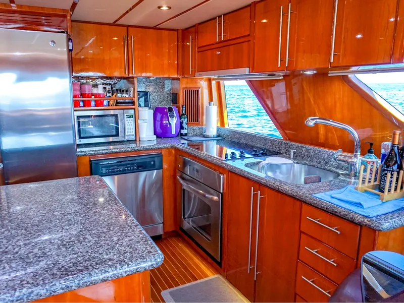 Slide: The Image of Luxurious kitchen in 2003 Hargrave Sky Lounge Motoryacht with modern appliances and wood cabinetry. - 12