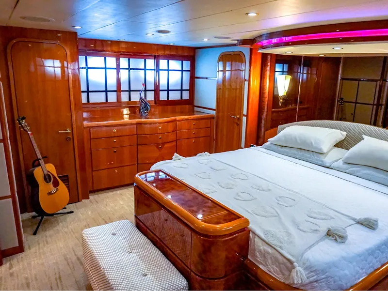 Slide: The Image of Luxurious 2003 Hargrave Sky Lounge Motoryacht bedroom with elegant wood finishes and a guitar. - 17