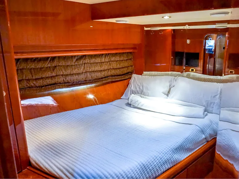Slide: The Image of Luxurious bedroom interior of 2003 Hargrave Sky Lounge Motoryacht with wood paneling and cozy bedding. - 27