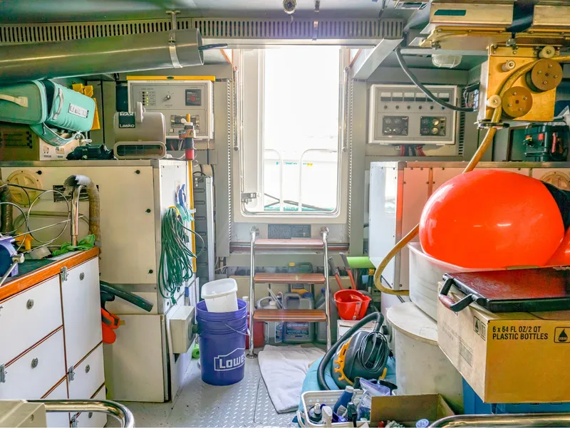 Slide: The Image of Engine room of 2003 Hargrave Sky Lounge Motoryacht, featuring equipment and storage items. - 32