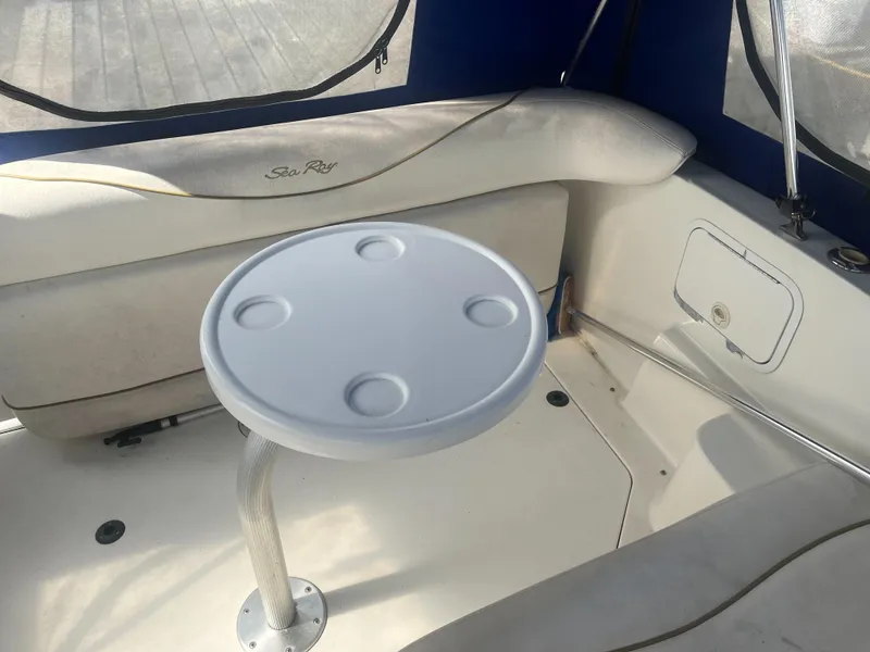 Slide: The Image of Interior of 2002 Sea Ray 260 Sundancer boat with round table and seating. - 19