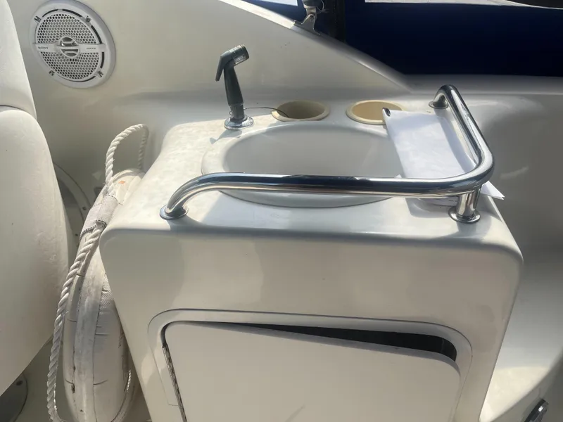 Slide: The Image of 2002 Sea Ray 260 Sundancer boat interior with sink and speaker. - 20