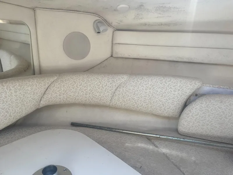 Slide: The Image of Interior cabin of a 2002 Sea Ray 260 Sundancer boat, featuring cushioned seating. - 7