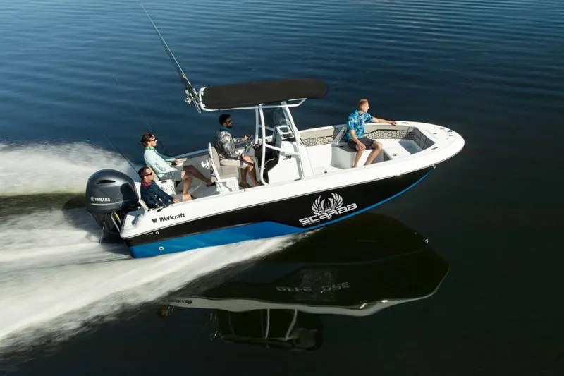 Slide: The Image of 2024 Wellcraft 202 Fisherman boat cruising on water with four passengers. - 1