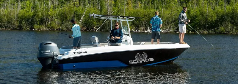 Slide: The Image of 2024 Wellcraft 202 Fisherman boat with anglers fishing on a calm lake. - 3