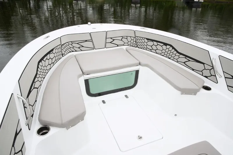 Slide: The Image of 2024 Wellcraft 202 Fisherman boat interior with cushioned seating and storage compartments. - 8