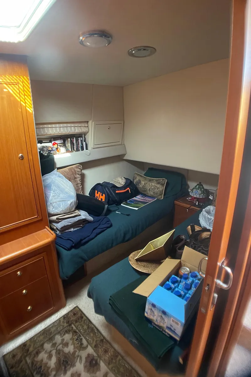 Slide: The Image of Cozy cabin interior of 2000 Riviera Flybridge yacht with bed and storage. - 11