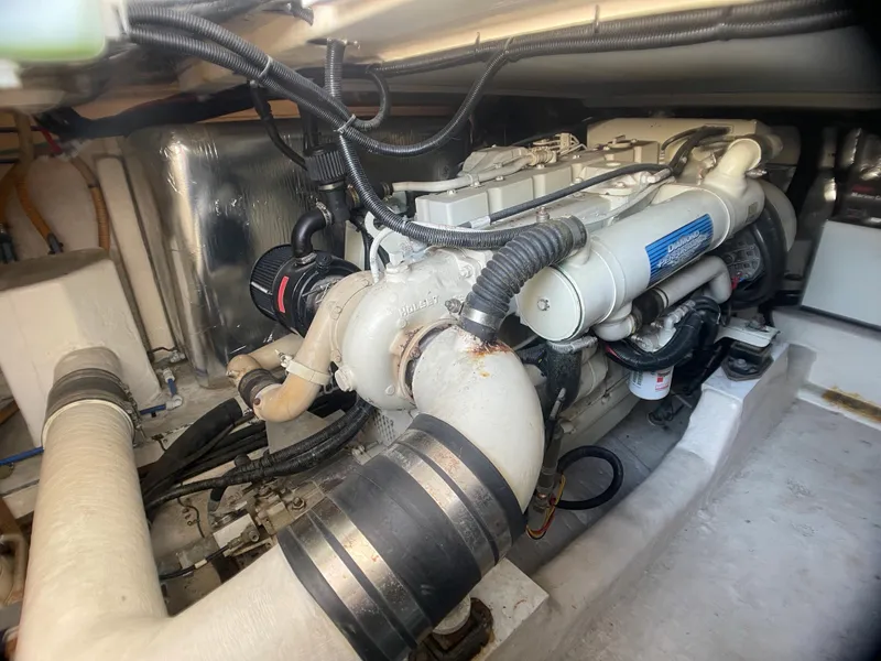 Slide: The Image of Engine room of a 2000 Riviera Flybridge boat, showcasing detailed mechanical components. - 19
