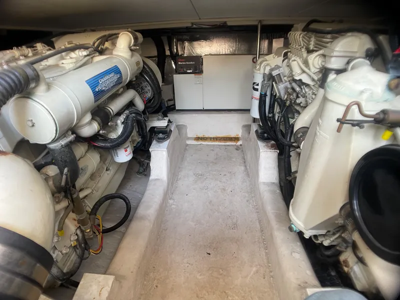 Slide: The Image of Engine room of a 2000 Riviera Flybridge yacht, showcasing dual engines and mechanical components. - 20