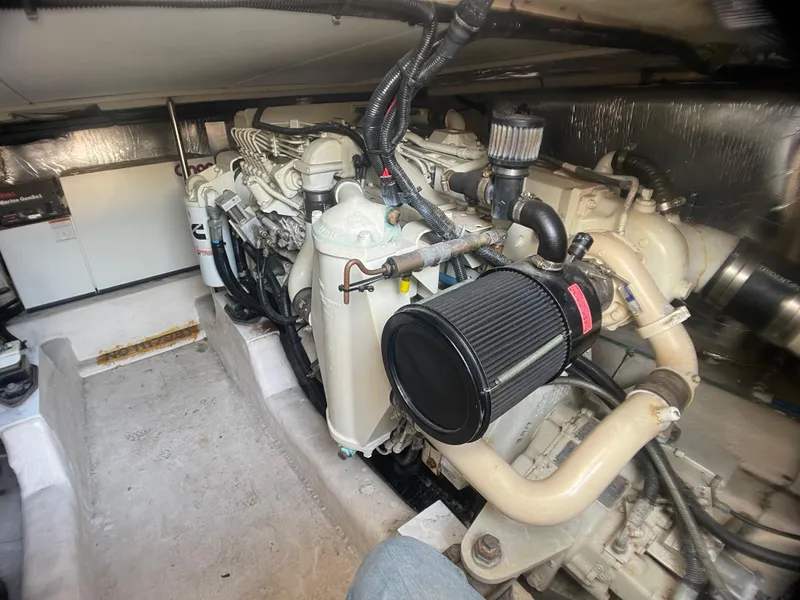 Slide: The Image of Engine room of a 2000 Riviera Flybridge boat, showcasing detailed mechanical components. - 21