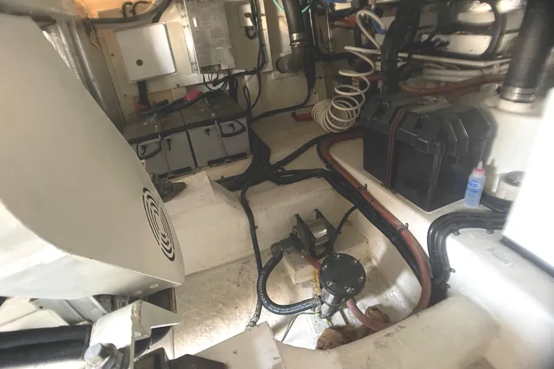 Slide: The Image of Engine room of a 2000 Riviera Flybridge boat, showcasing wiring and mechanical components. - 22