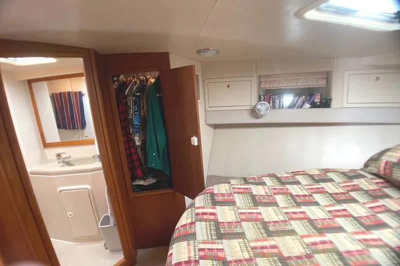 Slide: The Image of Bedroom and bathroom interior of 2000 Riviera Flybridge yacht with closet and bed. - 8