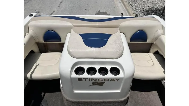 Slide: The Image of 1999 Stingray 200 CS/CX boat interior with beige and blue seating. - 14