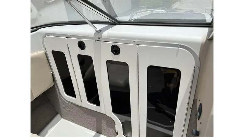 Slide: The Image of 1999 Stingray 200 CS/CX boat interior dashboard with storage compartments. - 4