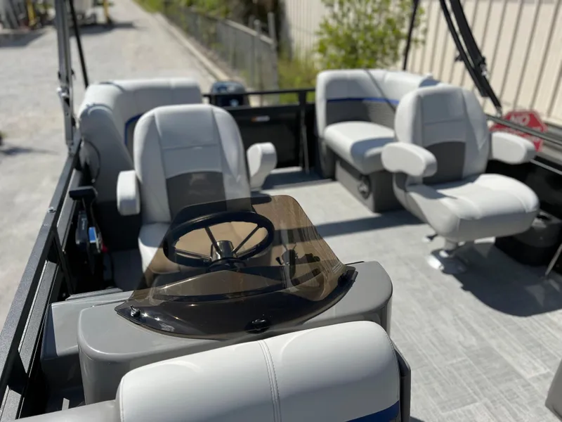Slide: The Image of 2024 Qwest RLS 818 boat interior with steering wheel and comfortable seating. - 13