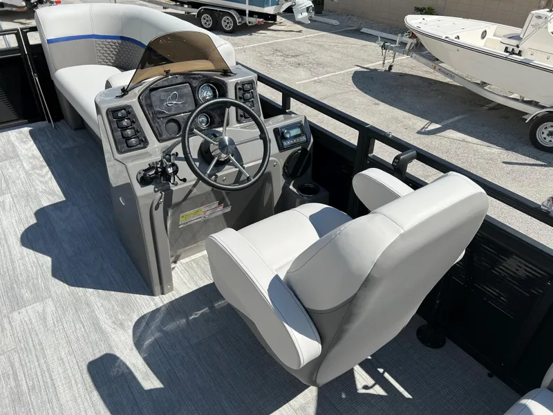Slide: The Image of 2024 Qwest RLS 818 boat interior with steering console and seating. - 16