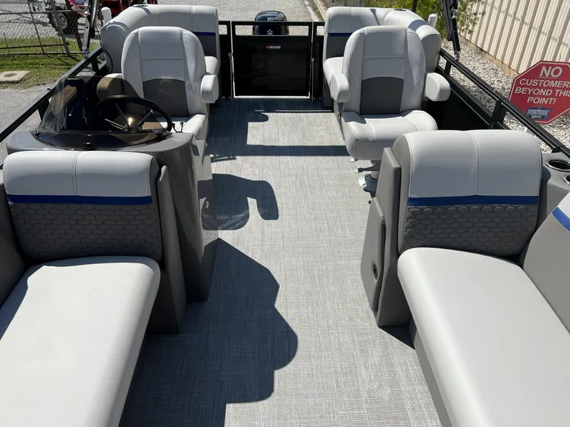 Slide: The Image of 2024 Qwest RLS 818 pontoon boat interior with gray seating and modern design. - 17