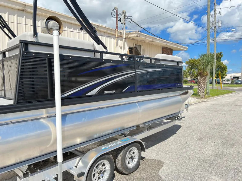 Slide: The Image of 2024 Qwest RLS 818 pontoon boat on trailer, parked outdoors. - 19