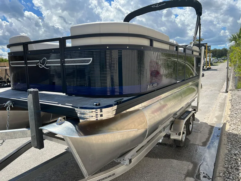 Slide: The Image of 2024 Qwest RLS 818 pontoon boat on trailer under a cloudy sky. - 21