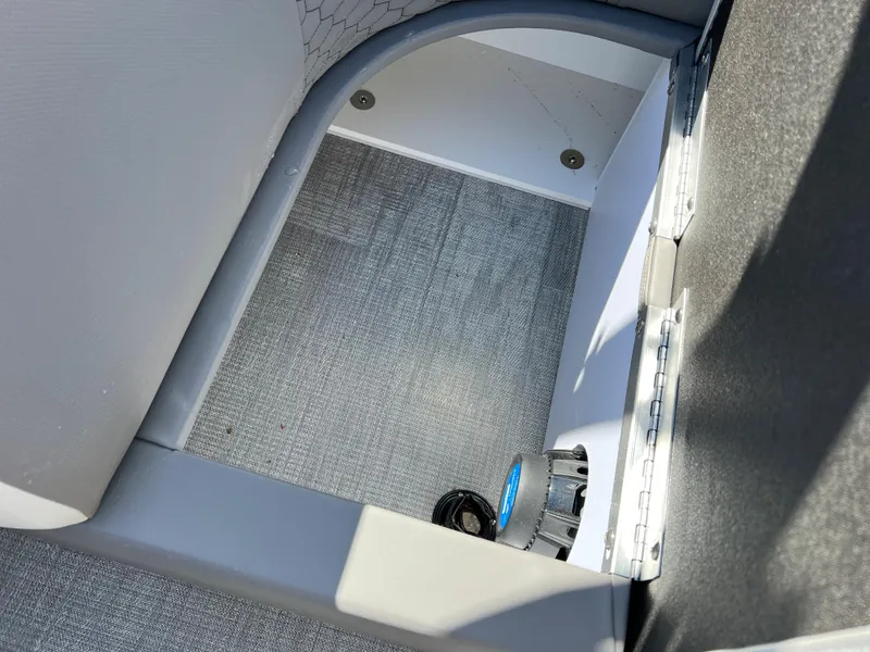 Slide: The Image of 2024 Qwest RLS 818 boat storage compartment with gray flooring and white interior. - 7