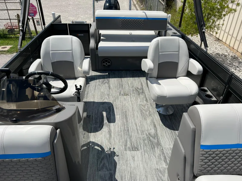 Slide: The Image of 2024 Qwest Splash Pad 822 boat interior with modern seating and steering console. - 11