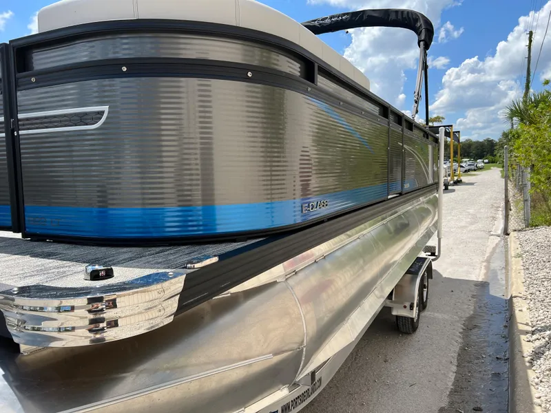 Slide: The Image of 2024 Qwest Splash Pad 822 pontoon boat on a sunny day. - 2