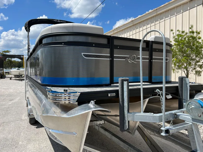 Slide: The Image of 2024 Qwest Splash Pad 822 pontoon boat on trailer under blue sky. - 3