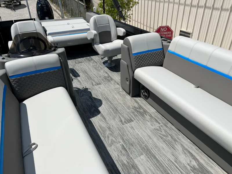 Slide: The Image of 2024 Qwest Splash Pad 822 boat interior with gray and blue seating. - 4