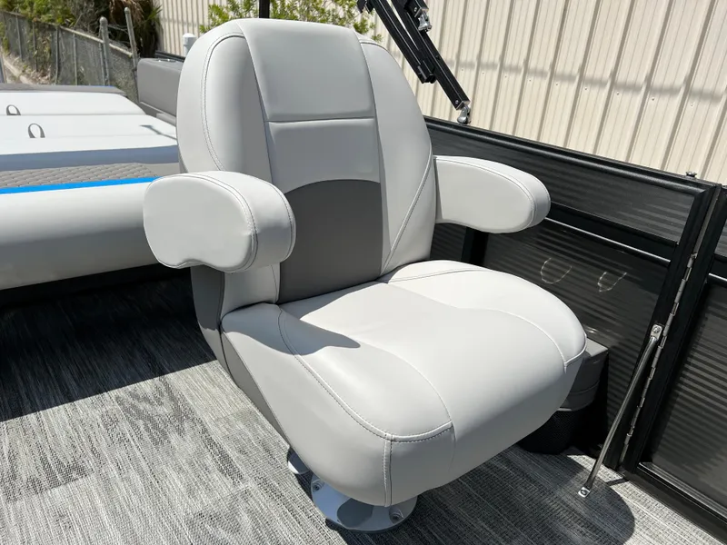 Slide: The Image of Qwest Splash Pad 822 2024 boat seat, gray leather, armrests, outdoor setting. - 5